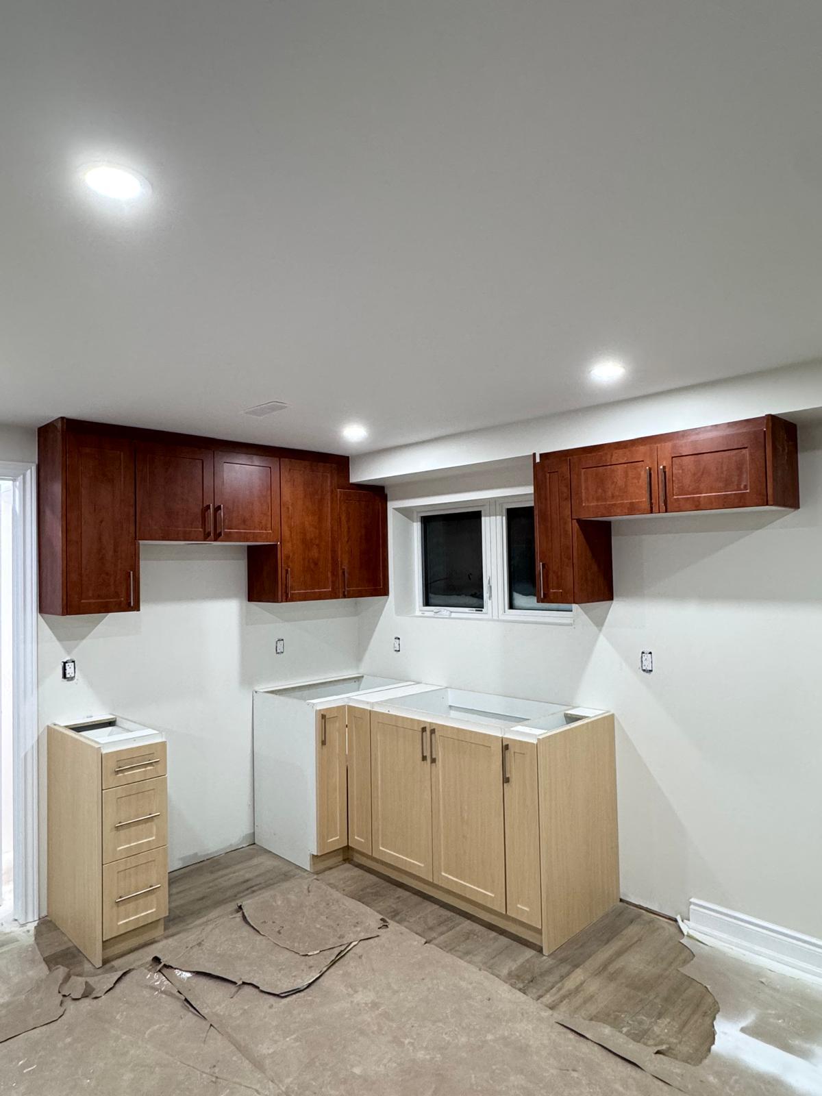 Cherry upper cabinets with light wood lower cabinets