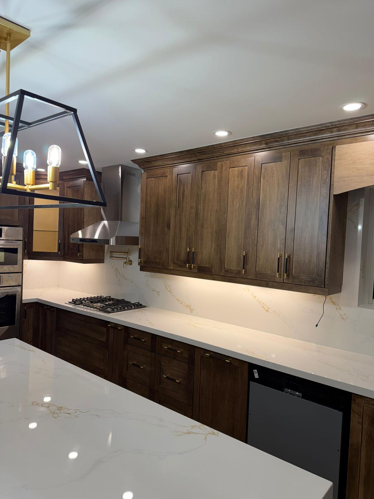 Custom dark walnut kitchen with brass hardware, by Nanak Kitchen Cabinets