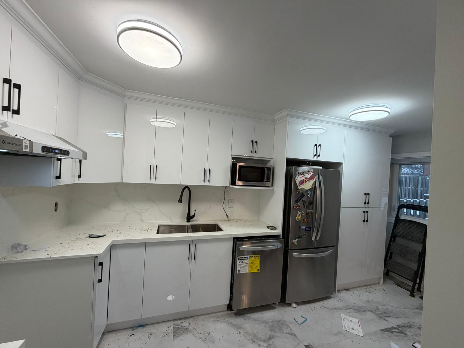 Glossy white kitchen with stainless appliances