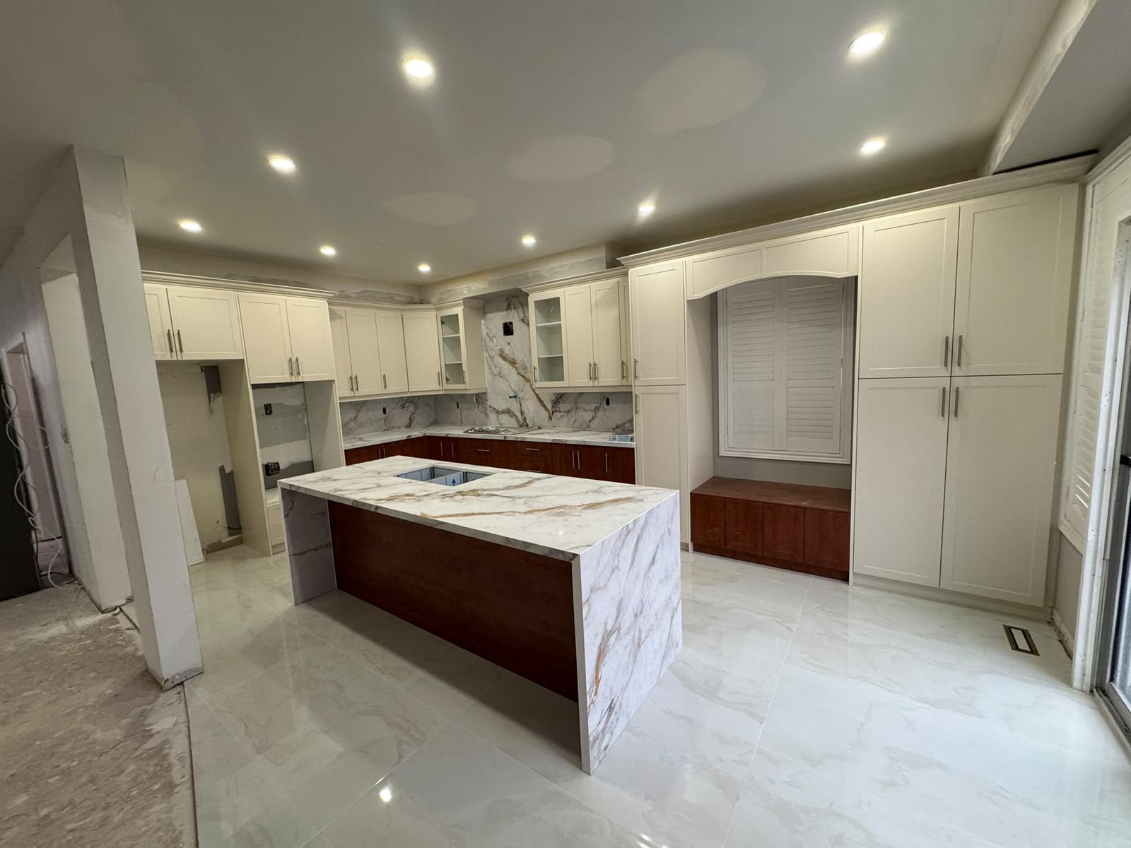 Waterfall island in cherry wood with marble quartz countertop